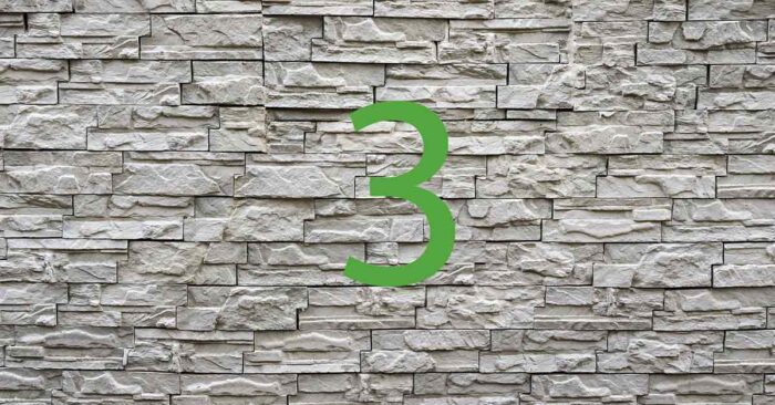 Haus aus dem 3D-Drucker Vor einer Steinmauer steht eine grüne 3 | Haus aus dem 3D-Drucker