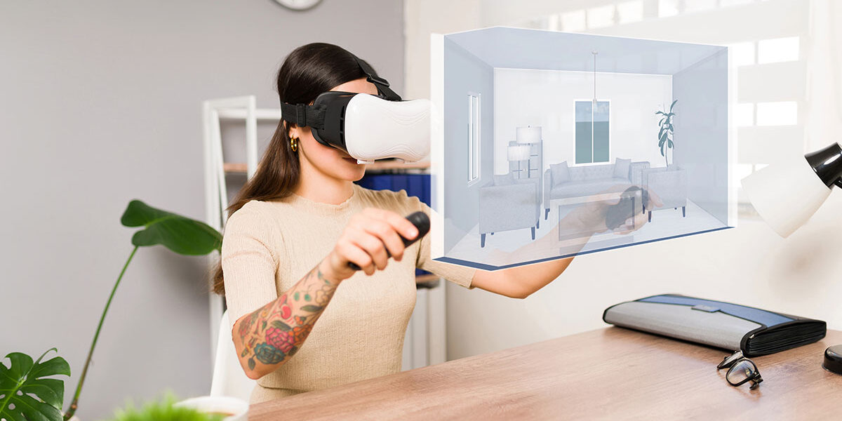 Virtuelle Immobilienbesichtigung Eine Frau mit VR-Brille und jeweils einem Controller in ihren Händen besichtigt in ihrem Wohnzimmer eine Immobilie, die symbolisch vor ihr virtuell dargestellt ist | Virtuelle Immobilienbesichtigung