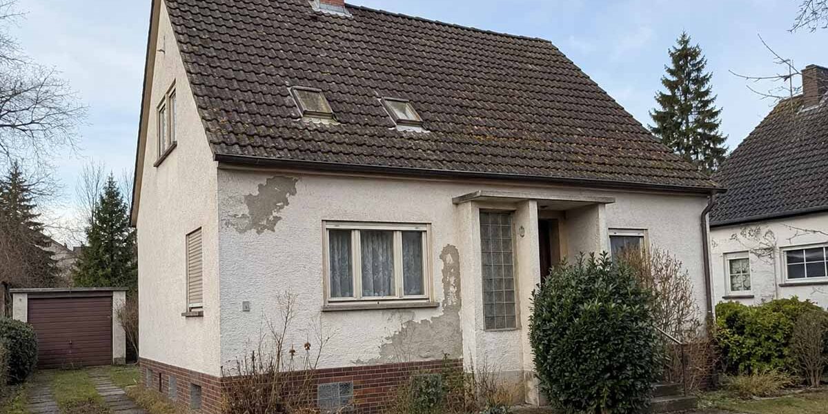 Sanierungspflicht beim Verkaufen Ein älteres Einfamilienhaus mit verwitterter Fassade und sanierungsbedürftigem Dach steht in einer Wohnstraße und symbolisiert die Entscheidung zwischen Modernisierung und Verkauf. I Sanierungspflicht beim Verkaufen